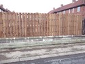 Wooden vertical panel fencing.